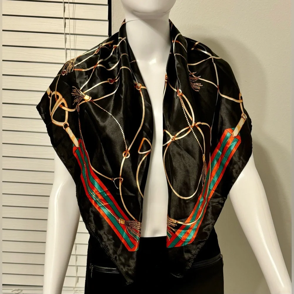 Fashionable women's black scarf with a chain and print. Polyester.
